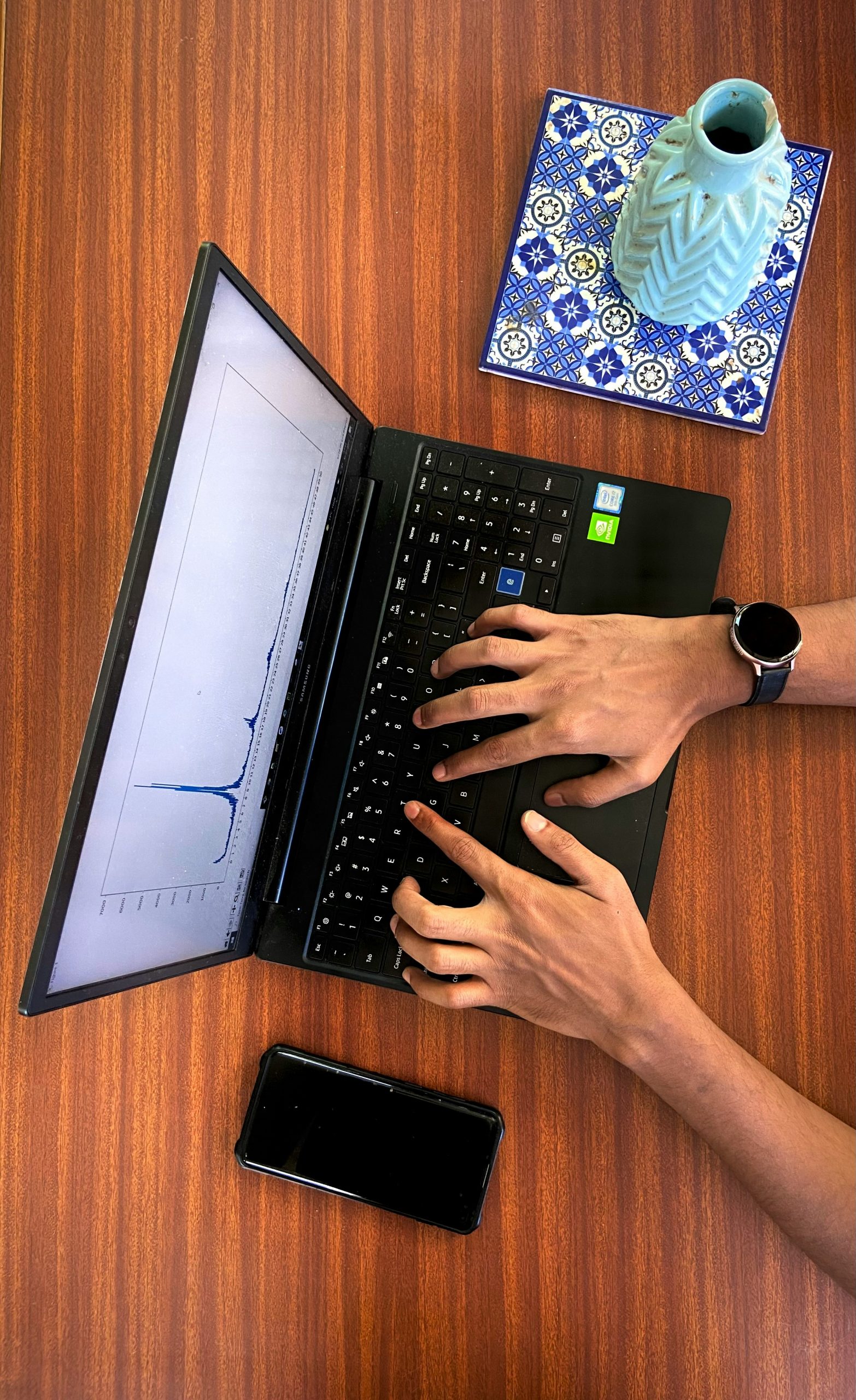 Unsplash image showing a calculator and financial graphs on a laptop screen, representing ROI analysis.