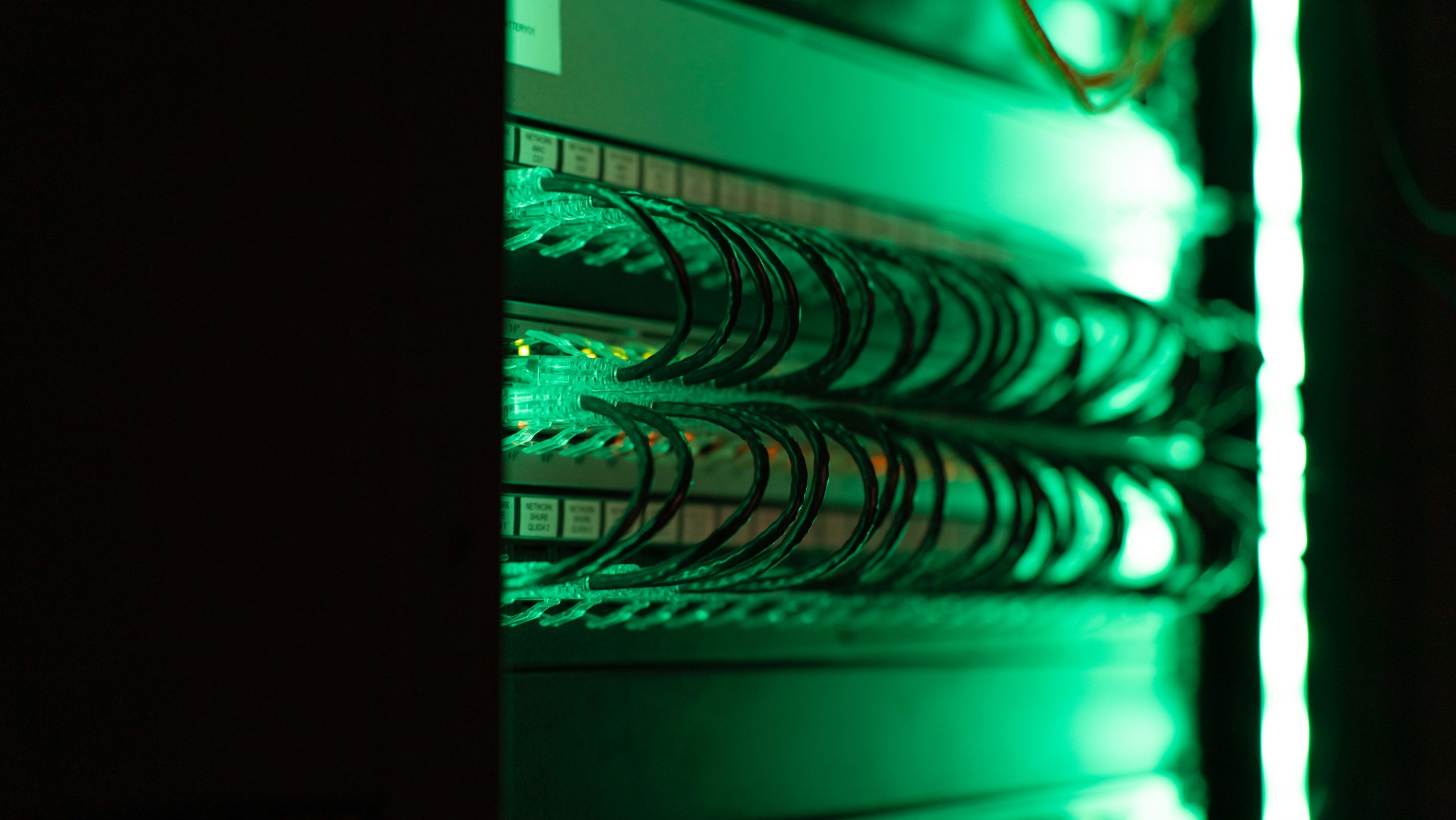 Close up of a server rack with green LED lights indicating security status focused and sharp