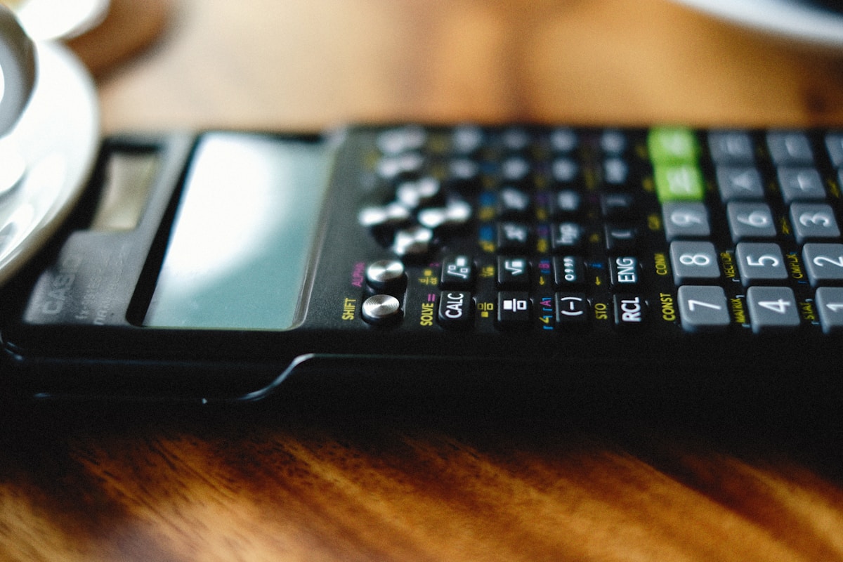 a calculator sitting on top of a wooden table