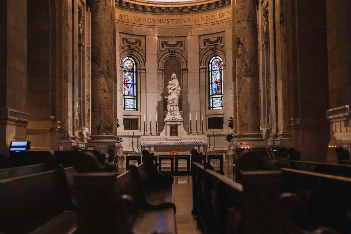 A church with pews and stained glass windows