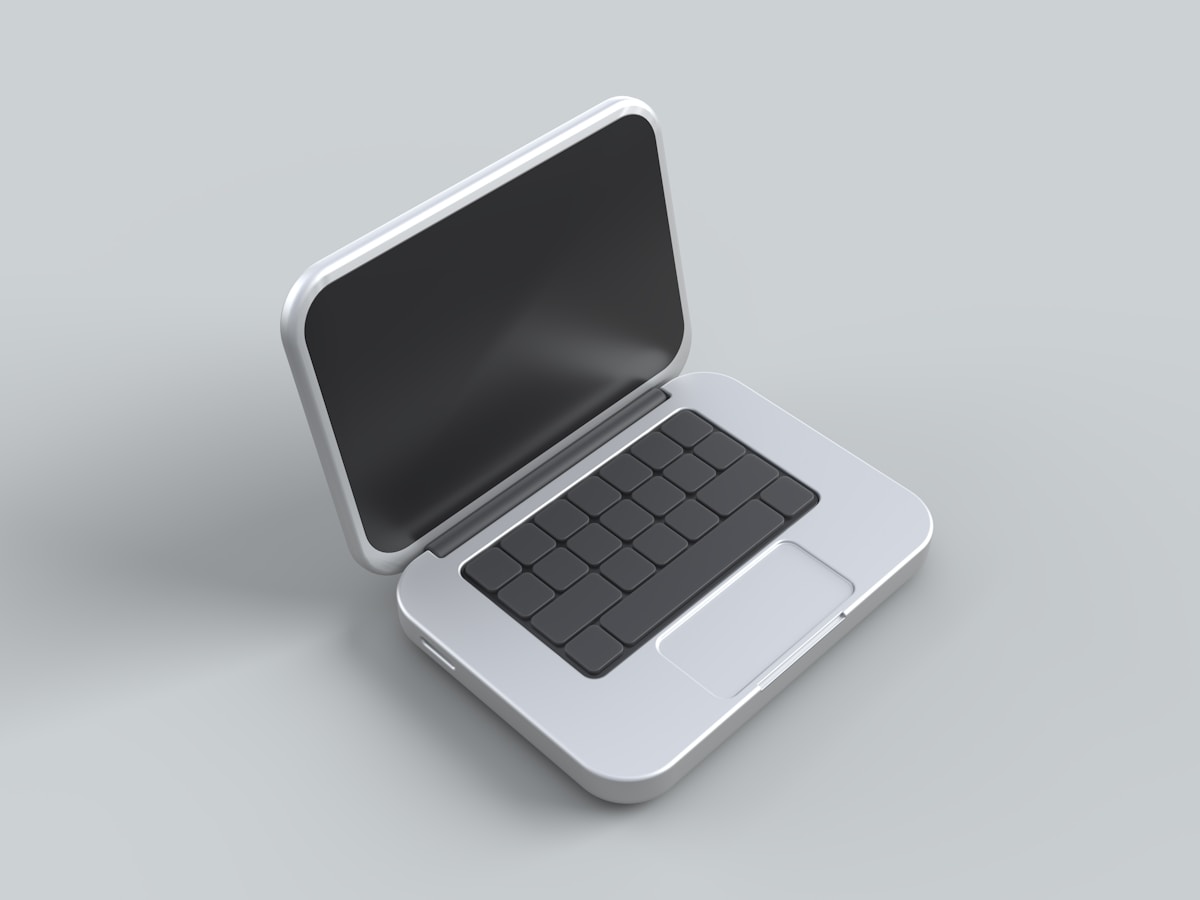 Ordinateur portable blanc avec clavier noir.