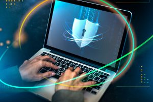 hands-typing-on-a-laptop-with-security-shield